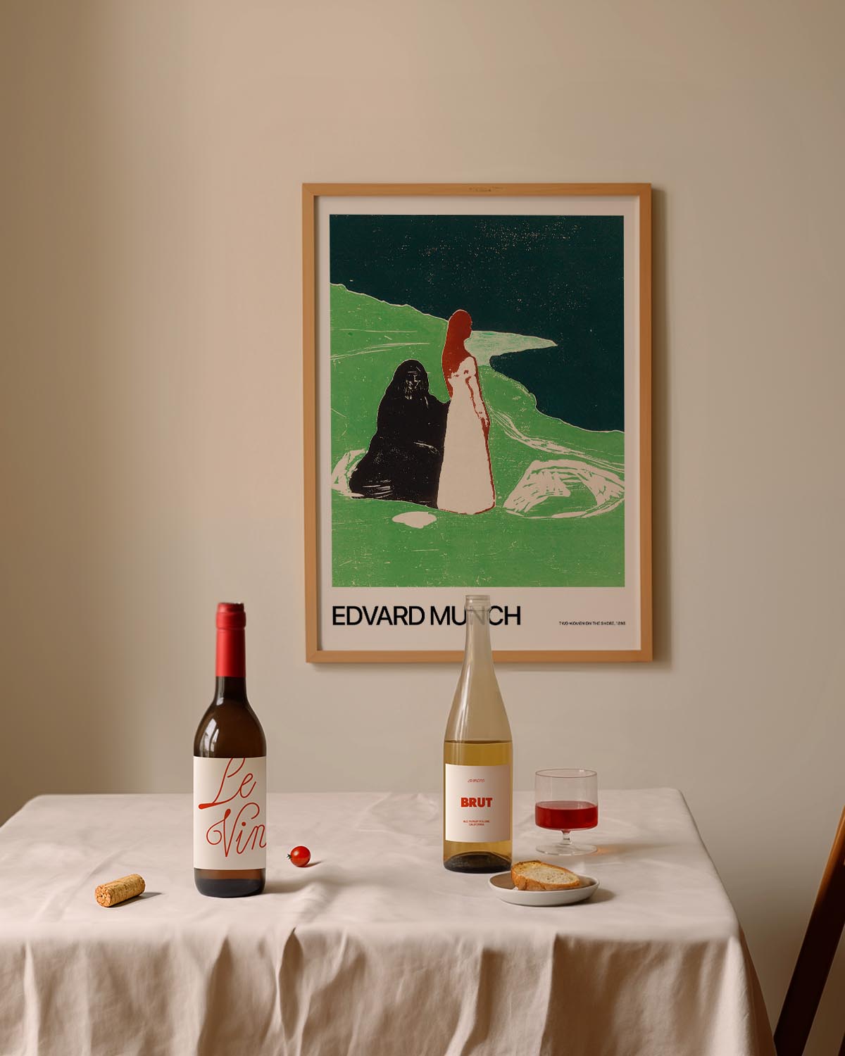 A print of Two Women on the Shore by Edvard Munch, featuring two female figures on a green shoreline with a dark sky, symbolic and moody in tone.