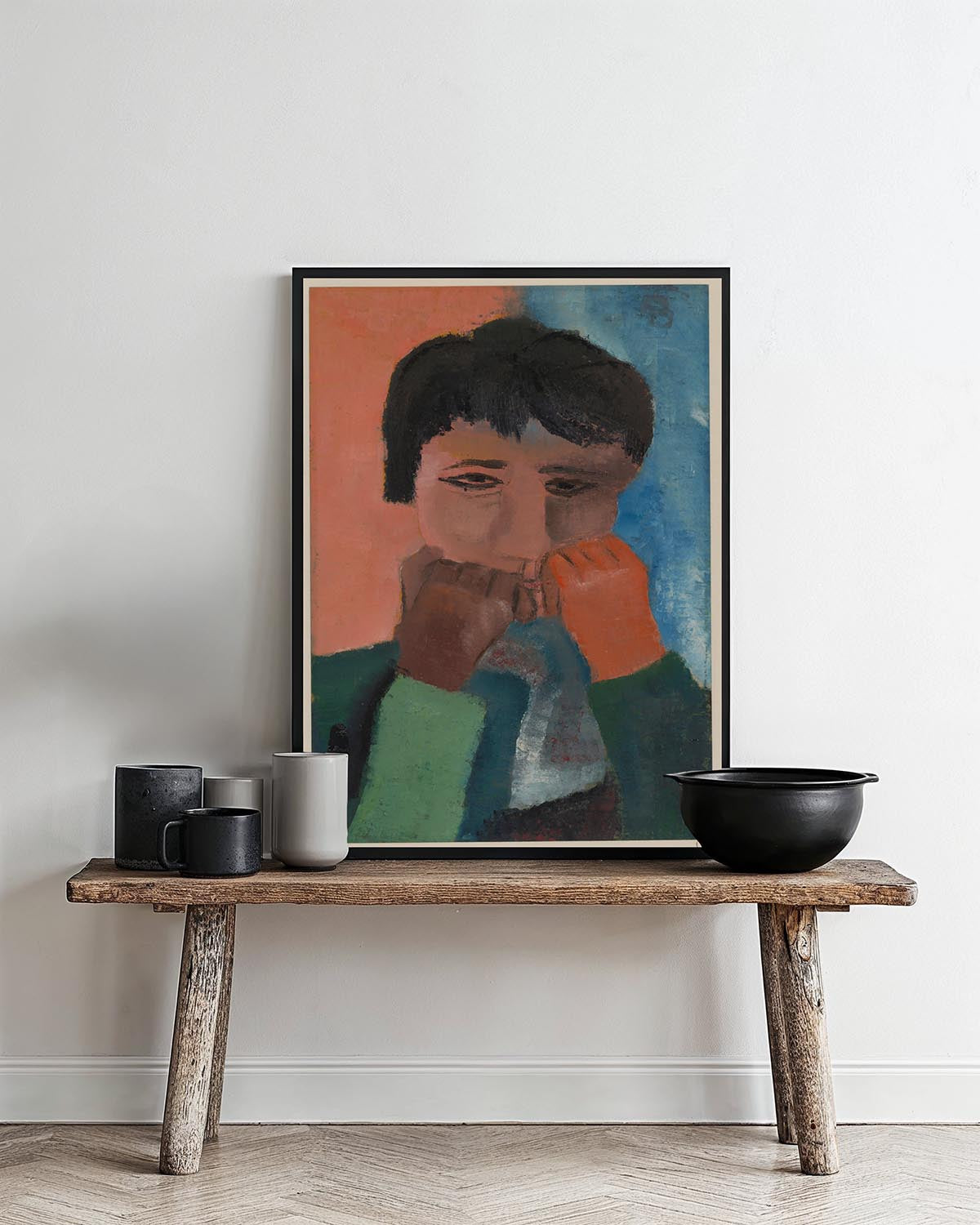 A colorful portrait poster by Hendrik Nicolaas Werkman featuring an abstract depiction of a figure with a contemplative expression. The figure's face is painted with simple, expressive lines against a backdrop of bold, contrasting colors—orange and blue.