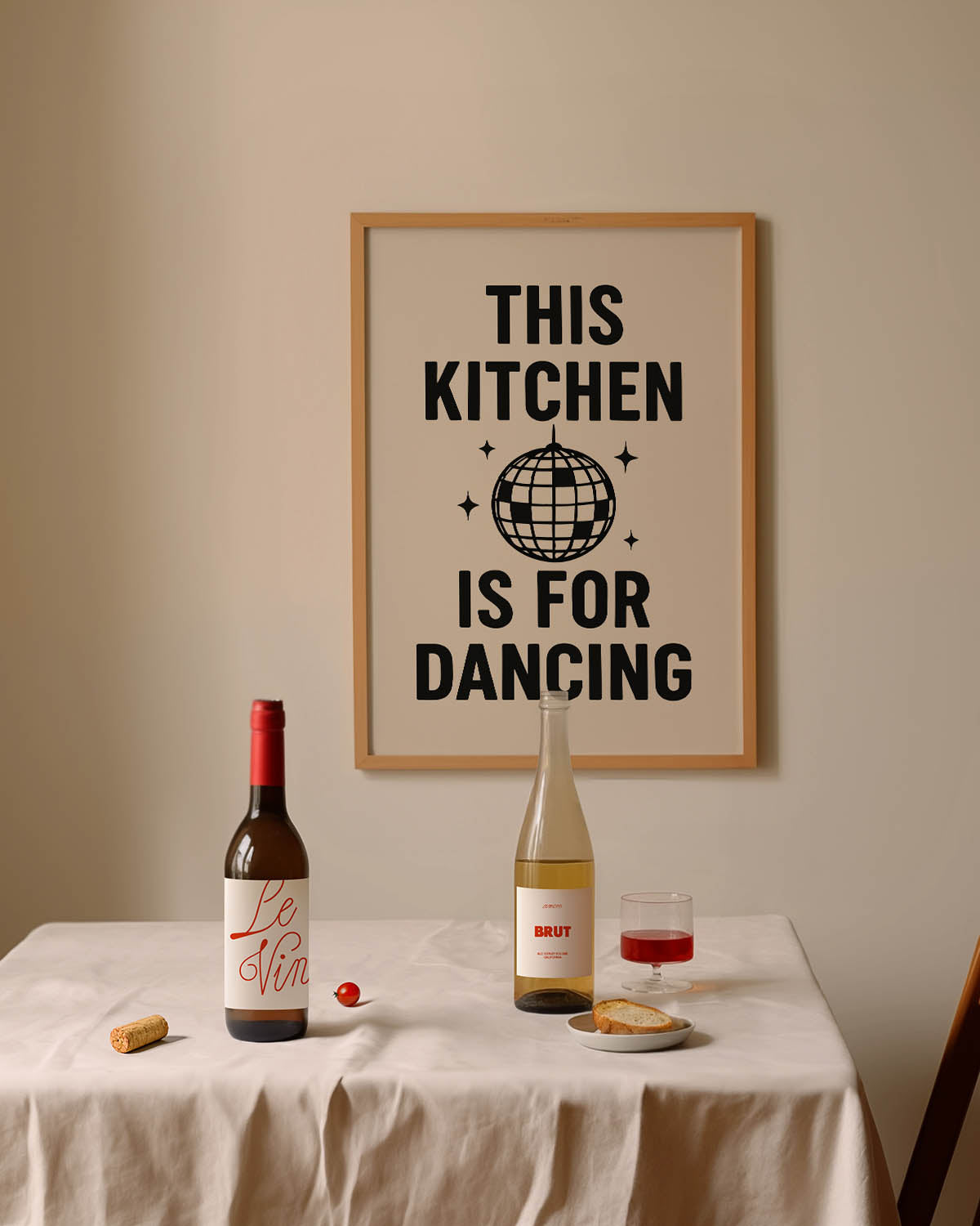 Black and white poster with bold text that reads “This Kitchen is for Dancing,” featuring a disco ball illustration in the center.