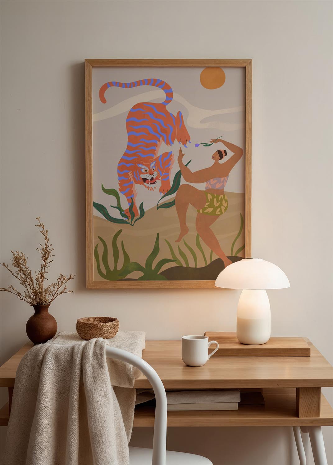 Illustration "Dance With Me" by Arty Guava, depicting a woman in patterned clothing dancing joyfully opposite a large, stylized orange and blue tiger against a beige landscape with a sun.