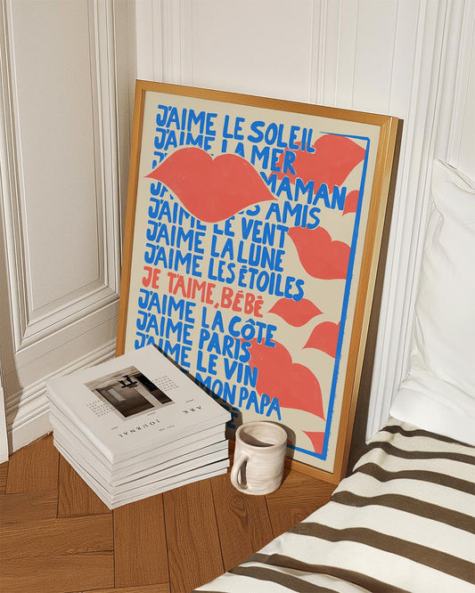 Poster with bold blue and red typography listing phrases of affection in French, such as 'I love the sun', 'I love the sea', 'I love my friends', with a large illustration of red lips in the center.