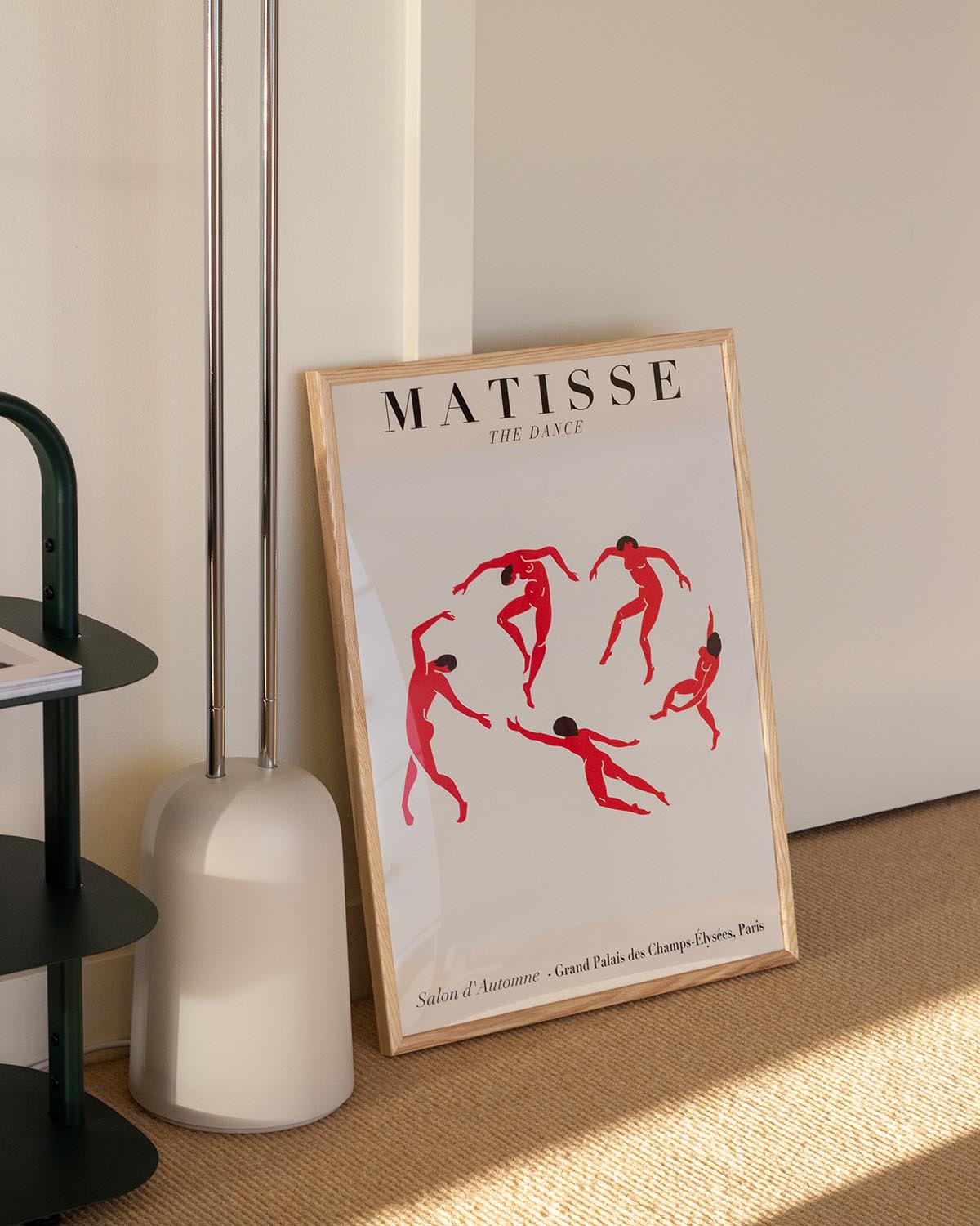 Minimalist poster featuring red abstract dancing figures from Matisse's "The Dance" on a beige background.