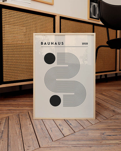 1919 Bauhaus poster with a beige background, showcasing black concentric curves and two solid black circles, topped with 'BAUHAUS' text.