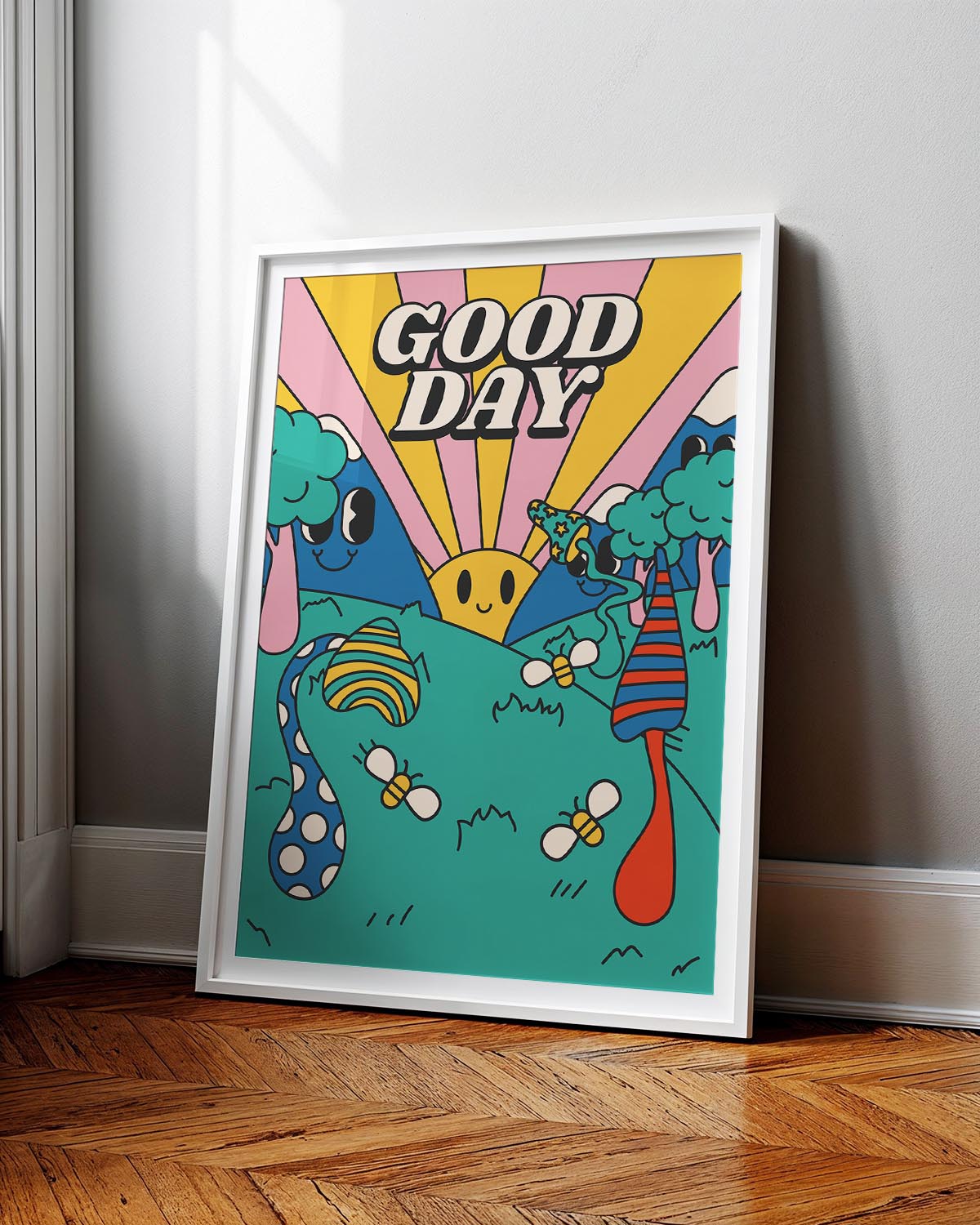 Colorful retro-style poster with a smiling sun, cartoon trees, playful bees, and the words “GOOD DAY” in bold letters against a pink and yellow sunrise background.