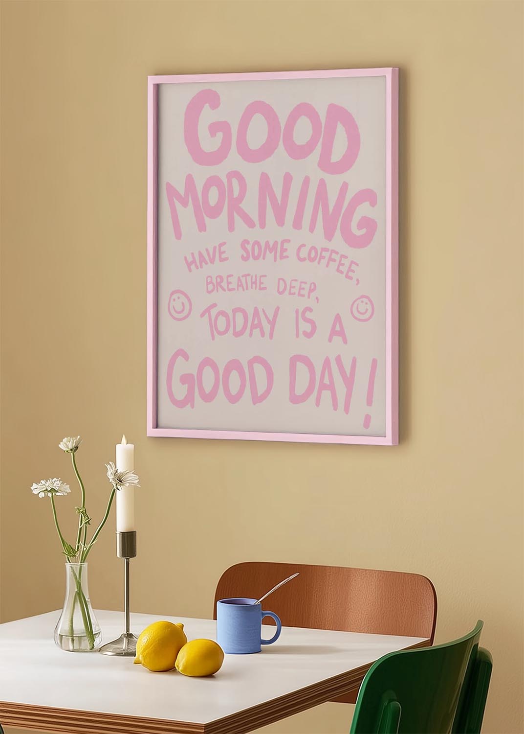 Poster with pink hand-lettered text that says “Good Morning, Have Some Coffee, Breathe Deep, Today is a Good Day!” with two smiley faces on a white background.