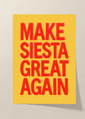 Make Siesta Great Again typography poster featuring bold red lettering on a mustard-yellow background, displayed in a natural wood frame above a dining table.