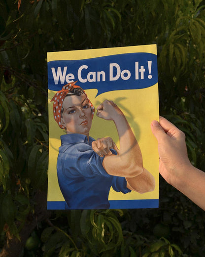 Iconic 'We Can Do It!' poster featuring Rosie the Riveter in blue work attire, flexing her arm against a yellow background.